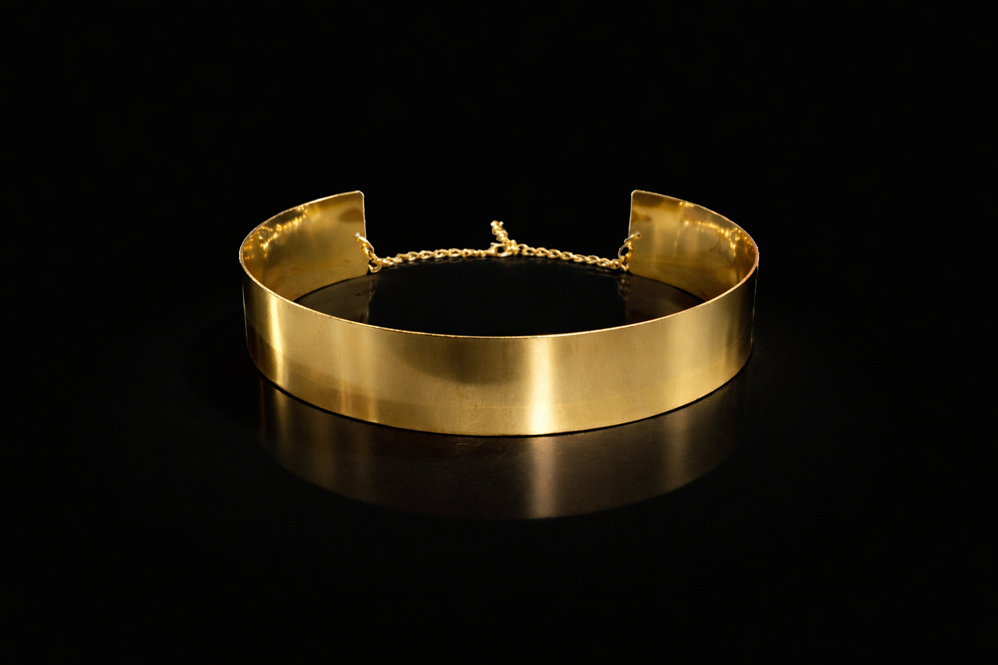 Gold choker necklace on a black background