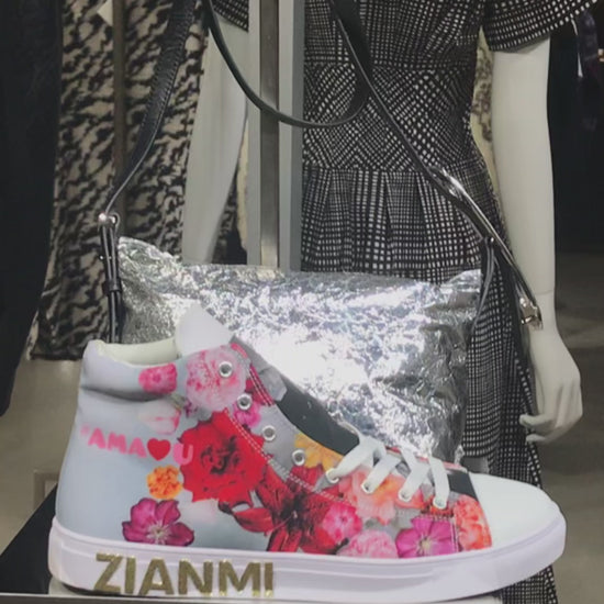 ZIANMI floral high-top sneaker displayed in a Paris boutique, featuring multicolored floral artwork, white laces and gold ZIANMI branding.