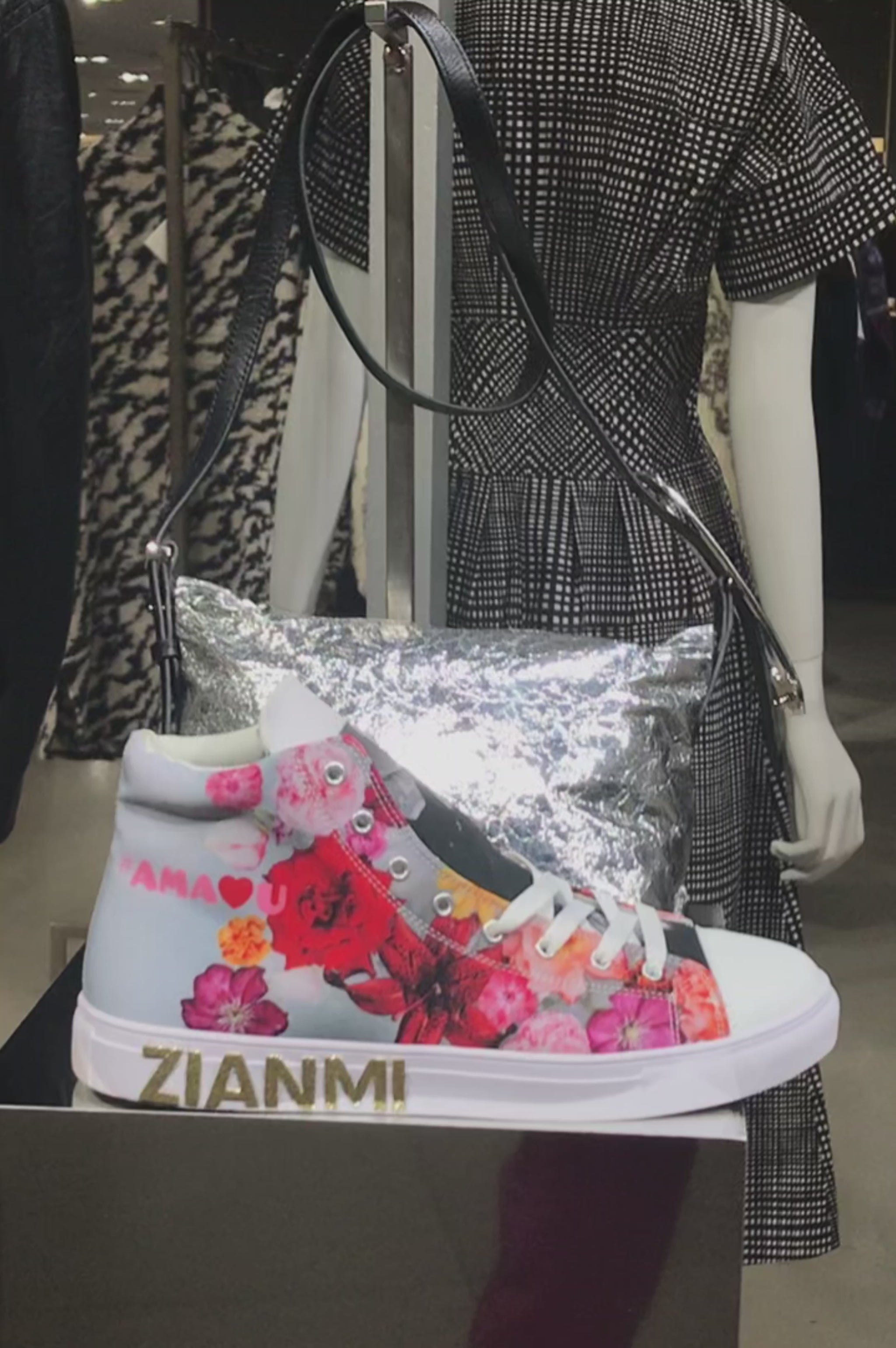 ZIANMI floral high-top sneaker displayed in a Paris boutique, featuring multicolored floral artwork, white laces and gold ZIANMI branding.